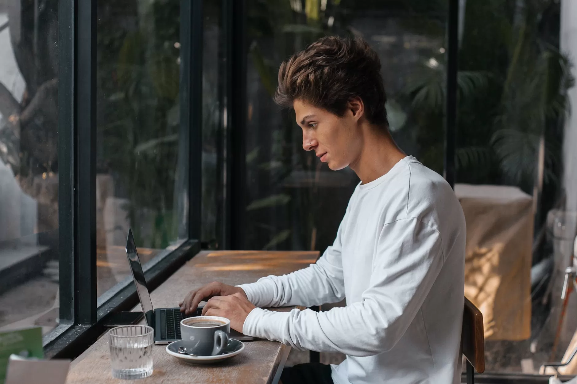 young man using laptop in a cafe